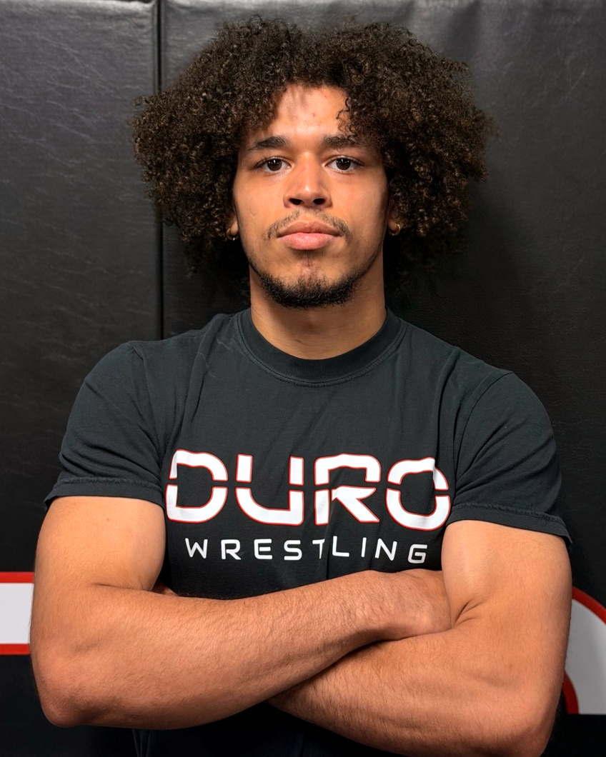Coach Xavier Pena wearing a DURO Wrestling shirt at the gym